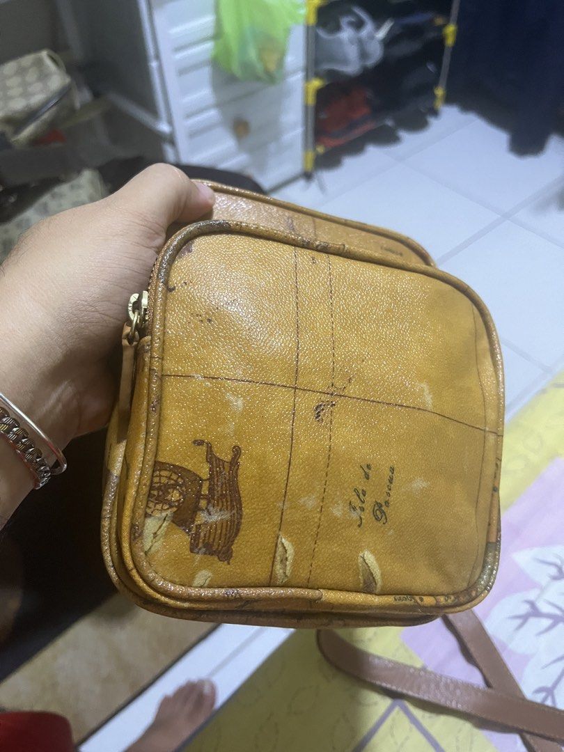 Alviero Martini Geo Map Crossbody Bag (Category: Luxury Bags & Wallets) located in Manila. Submitted by jankbaiteh05162 (Listing ID 1456624296, Image 2). Description: - Authentic Alviero Martini crossbody bag - Iconic geo map print - Genuine leather trim and strap - Two zippered compartments for organization - Gold-tone hardware - Adjustable strap for comfortable wear Slight issue sa harap pa check ng pic.