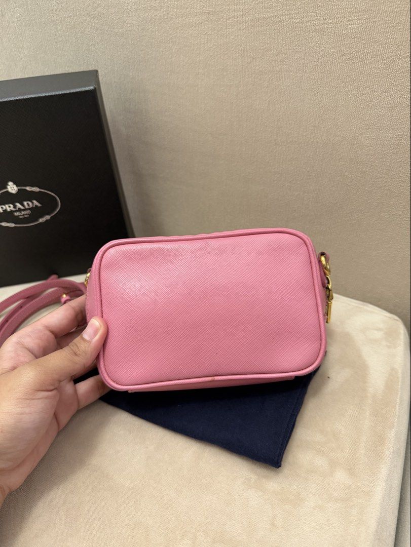 Authentic Prada Saffiano Mini Camera Bag (Category: Luxury Bags & Wallets) located in Manila. Submitted by maria_2326 (Listing ID 1450039991, Image 2). Description: Prada Saffiano Mini Camera Bag Baby Pink color Guarantee Authentic Promax CANNOT fit Inclusions: Provided box& dust bag Original Sling Location: Manila/QC .