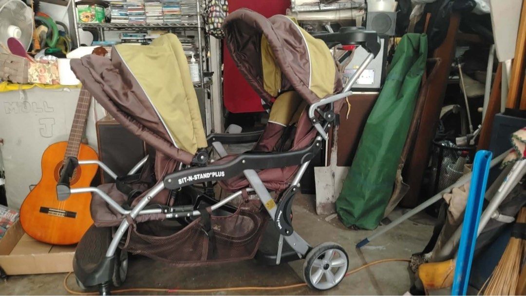 Baby Trend Sit-N-Stand Plus Double Stroller (Category: Strollers) located in Calamba. Submitted by rhiajapansurplus-babystuff-03 (Listing ID 1456606165, Image 2). Description: - Sit-N-Stand Plus stroller - perfect for two kids! - Versatile: Front seat for one, rear platform for another to stand. - Stylish brown and tan color scheme. - Convenient cup holder tray. - Spacious storage basket underneath. - Easy to maneuver for smooth rides. - Ideal fo