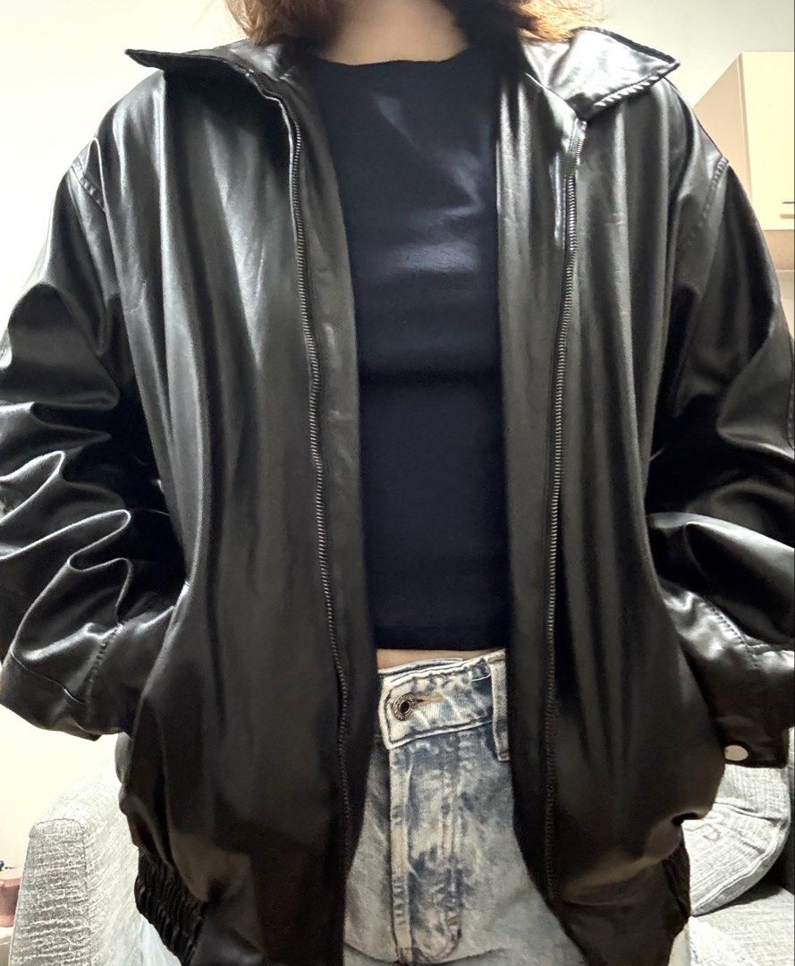 Black Faux Leather Bomber Jacket (Category: Coats, Jackets and Outerwear) located in Antipolo. Submitted by cherrycheolcart (Listing ID 1456766475, Image 1). Description: - Classic black bomber jacket - Made from faux leather - Features a zip-up front and collar - Ribbed hem and cuffs for a snug fit - Easily pairs with jeans or can be dressed up - Ideal for cooler weather.