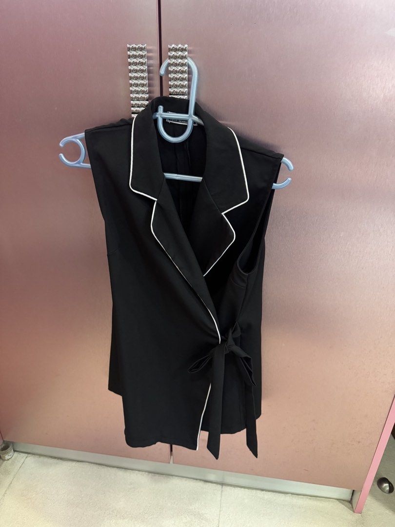 Black Sleeveless Vest with White Piping (Category: Sleeveless) located in Manila. Submitted by coclosets (Listing ID 1456627204, Image 1). Description: - Bought in Bangkok - Sleeveless black vest top (long) - White trim detail - Wrap front design - Secure tie closure - Adjustable fit - Ideal for layering - Sharp and stylish appearance.