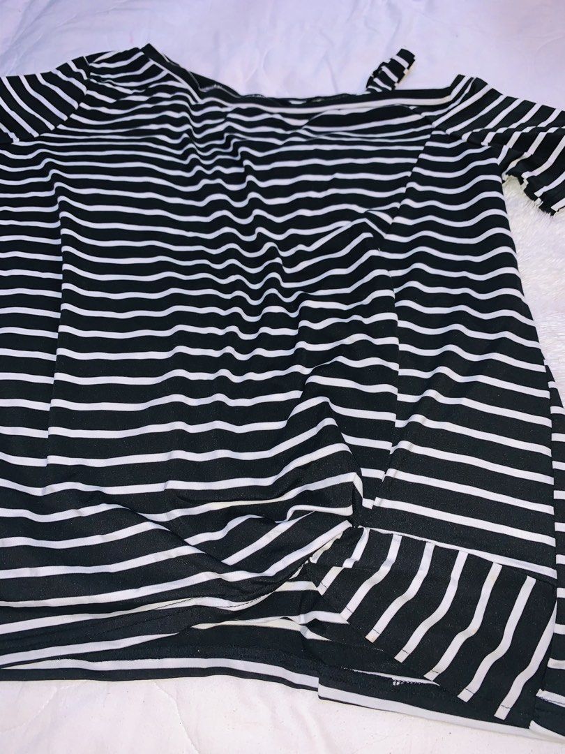 Black-and-white horizontal striped short-sleeve top (Category: Blouses) located in Pasig City. Submitted by nyca1989 (Listing ID 1456613592, Image 2). Description: Black-and-white horizontal striped short-sleeve top features an asymmetrical diagonal neckline with a unique cutout strap detail with tie design. Fits to XL - XXL Feel free to negotiate! Open to reasonable haggling. Let’s meet halfway and make a fair deal. Serious buyers are very welco