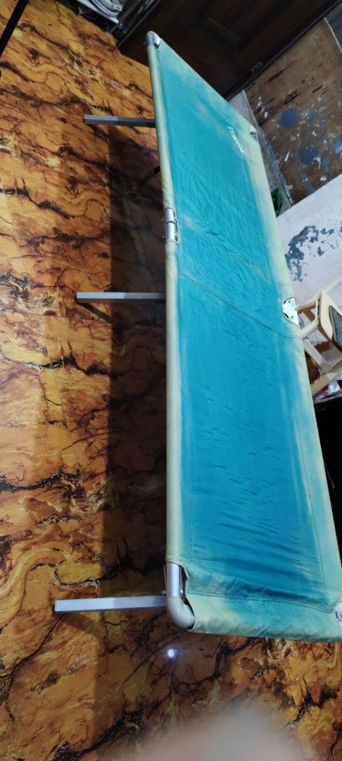 Blue Camping Cot Foldable Bed (Category: Hiking & Camping) located in Caloocan City. Submitted by rowely_jpn (Listing ID 1456631182, Image 3). Description: Selling a blue foldable camping cot. Sturdy metal frame. Fabric is a teal blue with some lighter discoloration. Measures about 77 inches long. Great for camping trips or as an extra bed. Folds up for easy storage and transport..