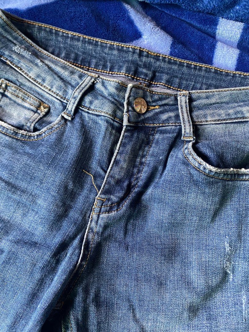 Blue Flared Jeans with Side Zips (Category: Jeans) located in Caloocan City. Submitted by lienzonius (Listing ID 1456679209, Image 2). Description: - Trendy blue denim jeans with a stylish flared leg - Features a classic zip and button front closure - Eye-catching distressed details and small rips on the legs - Unique raw, frayed hem edges for an edgy look - Convenient side zippers for added detail and fit - Ideal for creating a cool, casual outf