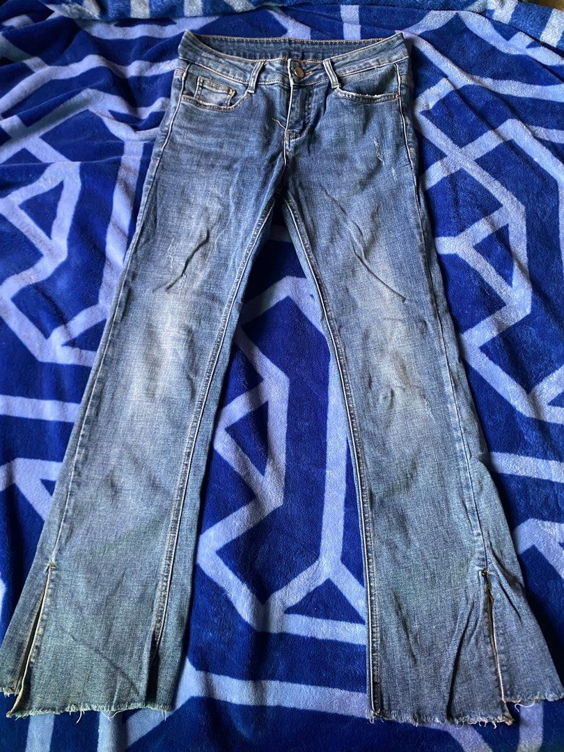 Blue Flared Jeans with Side Zips (Category: Jeans) located in Caloocan City. Submitted by lienzonius (Listing ID 1456679209, Image 1). Description: - Trendy blue denim jeans with a stylish flared leg - Features a classic zip and button front closure - Eye-catching distressed details and small rips on the legs - Unique raw, frayed hem edges for an edgy look - Convenient side zippers for added detail and fit - Ideal for creating a cool, casual outf