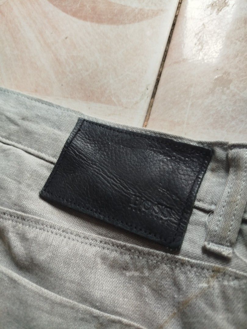 BOSS Hugo Boss Grey Herringbone Trousers (Category: Trousers) located in Abucay. Submitted by ukay_withdj (Listing ID 1456687894, Image 3). Description: - Grey BOSS Hugo Boss trousers - Classic fit - Herringbone pattern fabric - Two back pockets - Leather patch on back waistband - Ideal for casual or smart casual outfits - Please check photos for condition details.