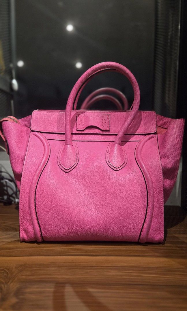 CELINE PINK MINI LUGGAGE (Category: Luxury Bags & Wallets) located in Meycauayan. Submitted by tuschy (Listing ID 1456684561, Image 2). Description: Brand: Celine ParisModel: Luggage Tote (Mini) Material: Premium pebbled calfskin leather (exceptionally durable and scratch-resistant) Color: Hot Pink / Neon Fuchsia with contrasting black edge painting Hardware: Silver-tone zipper and structural accents Interior: Ultra-soft, tonal suede/leather lini