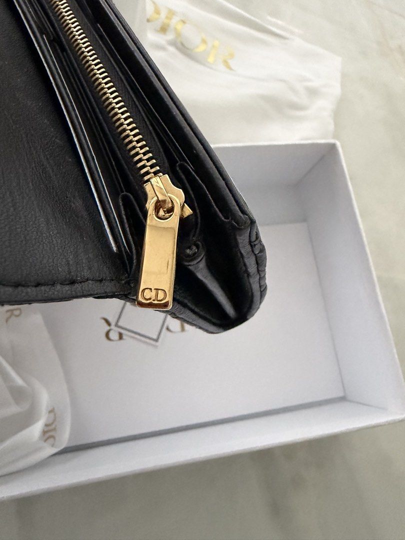 Authentic Christian Dior Black Leather Caro Wallet (Category: Luxury Bags & Wallets) located in Taguig. Submitted by claire08hyun (Listing ID 1456719150, Image 3). Description: - Authentic Christian Dior black leather wallet - Features iconic cannage stitching - Gold-tone CD hardware on the front - Interior: Card slots and a zip compartment - Comes with original dust bag and box -Calfskin leather -with store receipt -rfs: kept unused.