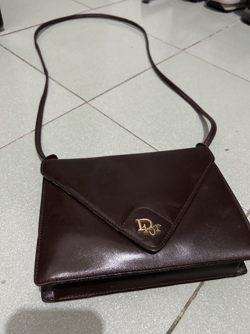 Christian Dior Brown Leather Envelope Shoulder Bag (Category: Luxury Bags & Wallets) located in Angeles City. Submitted by cassey_phoenix (Listing ID 1456727446, Image 1). Description: - Authentic Vintage Christian Dior Shoulder Bag - Made in Spain - Classic Brown Leather - Signature Gold 'CD' Logo - Elegant Envelope Style Flap Closure - Secure Snap Button Fastening - Interior Zip Pocket for Essentials - Versatile for Everyday or Special Occasion