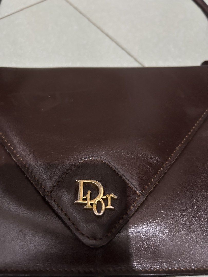Christian Dior Brown Leather Envelope Shoulder Bag (Category: Luxury Bags & Wallets) located in Angeles City. Submitted by cassey_phoenix (Listing ID 1456727446, Image 2). Description: - Authentic Vintage Christian Dior Shoulder Bag - Made in Spain - Classic Brown Leather - Signature Gold 'CD' Logo - Elegant Envelope Style Flap Closure - Secure Snap Button Fastening - Interior Zip Pocket for Essentials - Versatile for Everyday or Special Occasion
