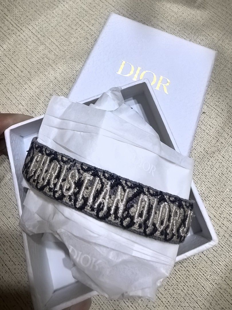 Christian Dior Embroidered Bracelet (Category: Bracelets) located in Taguig. Submitted by undet27 (Listing ID 1436875357, Image 1). Description: - Brand: Christian Dior - Design: Embroidered - Band: Woven with tassel - Features: Adjustable - Colors: Navy and beige - Style: Versatile accessory for various occasions.
