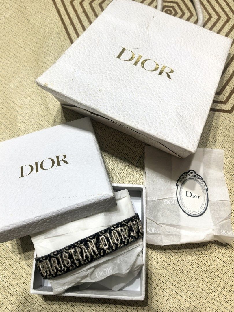 Christian Dior Embroidered Bracelet (Category: Bracelets) located in Taguig. Submitted by undet27 (Listing ID 1436875357, Image 2). Description: - Brand: Christian Dior - Design: Embroidered - Band: Woven with tassel - Features: Adjustable - Colors: Navy and beige - Style: Versatile accessory for various occasions.