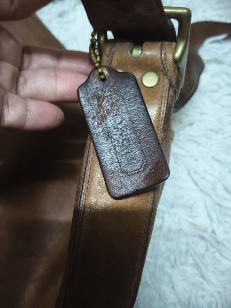 Coach Brown Leather Studded Shoulder Bag (Category: Luxury Bags & Wallets) located in Pasay City. Submitted by cory0223 (Listing ID 1456770792, Image 3). Description: - Authentic Coach brown leather shoulder bag - Stylish brass stud accents on front pocket and sides - Interior includes a zippered pocket and slip pockets for organization - Beautiful worn-in leather patina - Adjustable strap for comfortable wear - Ideal everyday bag.