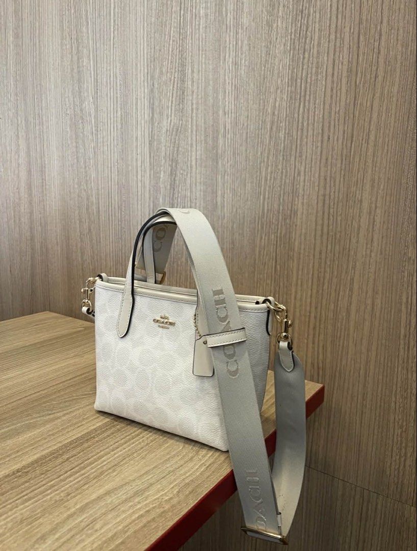 Coach Mini City (Category: Luxury Bags & Wallets) located in Manila. Submitted by fairytale_nami (Listing ID 1456704356, Image 1). Description: - Authentic White Coach Tote Bag - Signature Coach Pattern - Adjustable Long Strap Included - Elegant Gold Hardware Details - Small Tag Attached - Ideal for Everyday Use -Mini city.