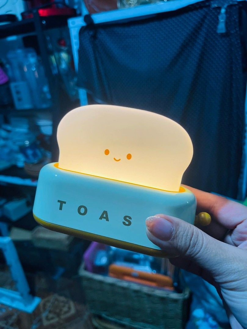 Cute Toast Shaped Night Light Lamp (Category: Lighting) located in Manila. Submitted by reascheyss51406 (Listing ID 1456696525, Image 2). Description: - Adorable toast-shaped night light - Emits a warm, soft glow - Ideal for bedside tables or as a decorative piece - Battery operated for convenience - Creates a cozy atmosphere in any room - Perfect gift for kids or anyone who loves cute items.