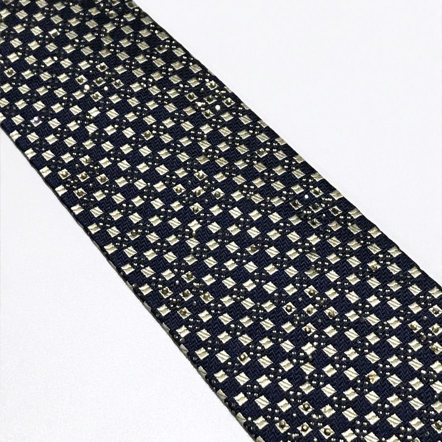 Daniel Hechter Embellished Jacquard Geometric Neck Tie (Category: Ties) located in Taguig. Submitted by retrogaze (Listing ID 1456628323, Image 3). Description: This silk-poly blend necktie by Daniel Hechter features a deep navy blue base crafted with an intricate jacquard-woven texture. The body is detailed with a structured geometric grid pattern in pale silver-gold accents, elevated by subtle rhinestone embellishments scattered across the uppe