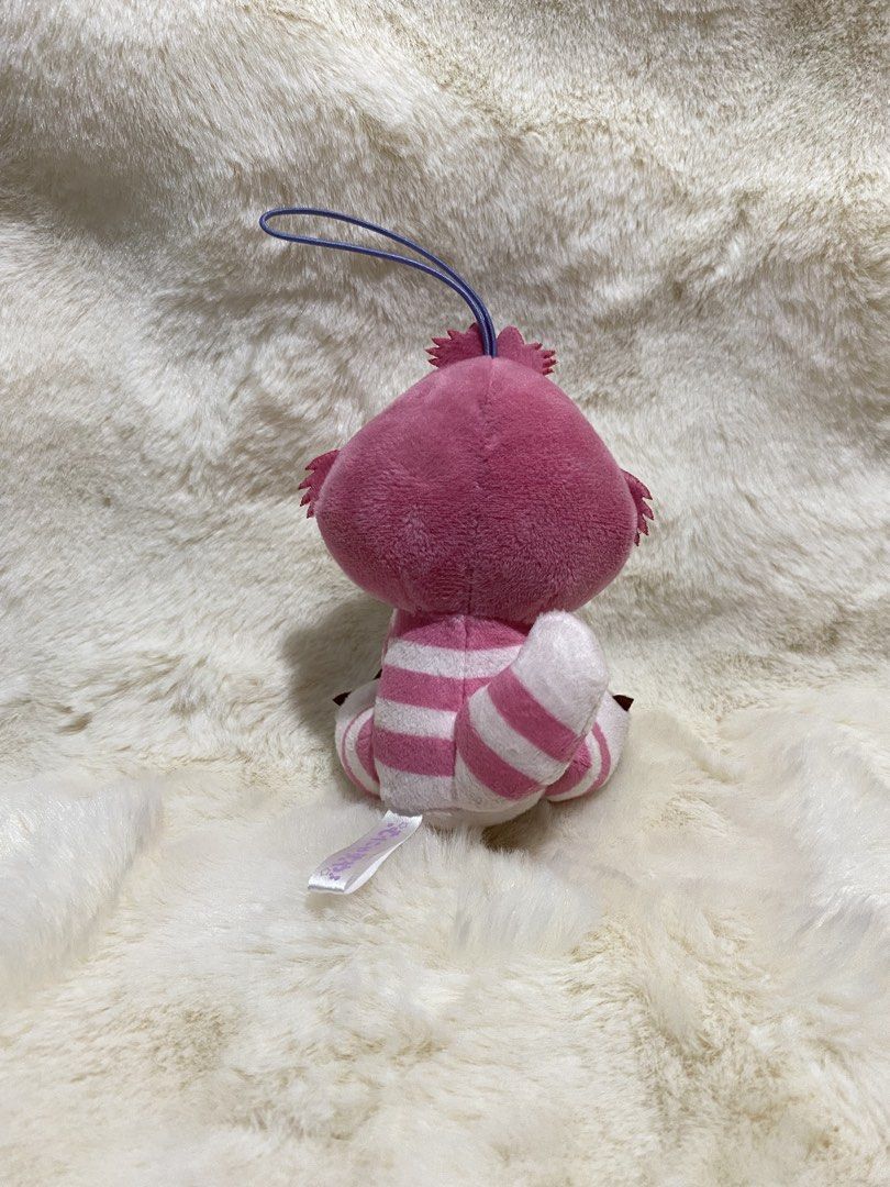 Disney Cheshire Cat Plush charm Keychain (Category: Plushies & Soft Toys) located in Kalibo. Submitted by ollie_stuffshop (Listing ID 1456629452, Image 2). Description: Before you send your inquiries: ❗️Last Price is already posted ❗️Manage your expectations, WYSIWYG ❗️May need washing ❗️Shipping day is every Sunday - Adorable Cheshire Cat plush toy - Features iconic pink and white stripes - Includes a convenient loop for hanging - Ideal for atta