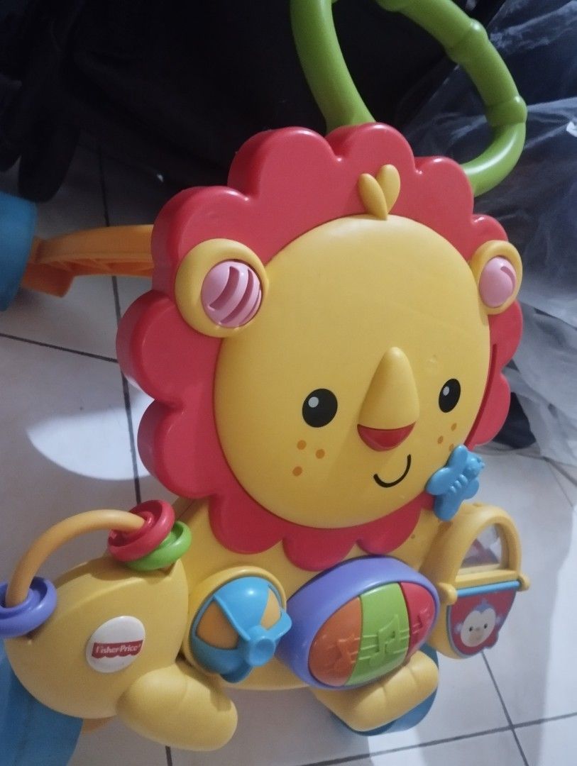 Fisher-Price Lion Walker Toy (Category: Infant Playtime) located in Manila. Submitted by ljaneee (Listing ID 1456625331, Image 2). Description: - Fisher-Price Lion Walker - Lots of interactive buttons and sounds - Helps baby learn to walk - Great for developing motor skills.