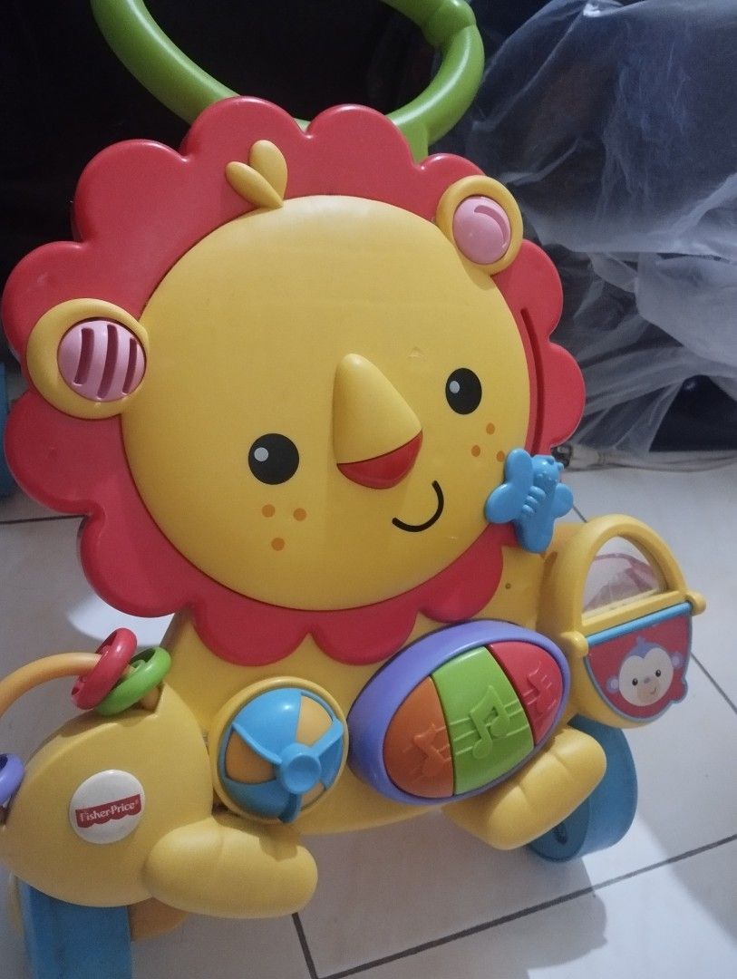 Fisher-Price Lion Walker Toy (Category: Infant Playtime) located in Manila. Submitted by ljaneee (Listing ID 1456625331, Image 3). Description: - Fisher-Price Lion Walker - Lots of interactive buttons and sounds - Helps baby learn to walk - Great for developing motor skills.