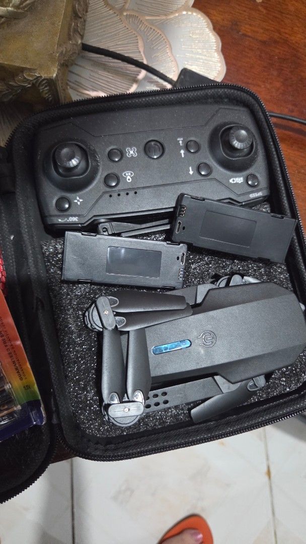 Foldable Drone with Remote and Carrying Case (Category: Drones) located in Quezon City. Submitted by kctheexplorer05 (Listing ID 1456688459, Image 2). Description: - Black foldable drone - Includes remote control and charging cables - Comes with a black carrying case - Two (2) batteries included - Ideal for aerial photography and videography - Ready to fly out of the box Perfect for those who wants to get their own drone RFS- used twice only to t