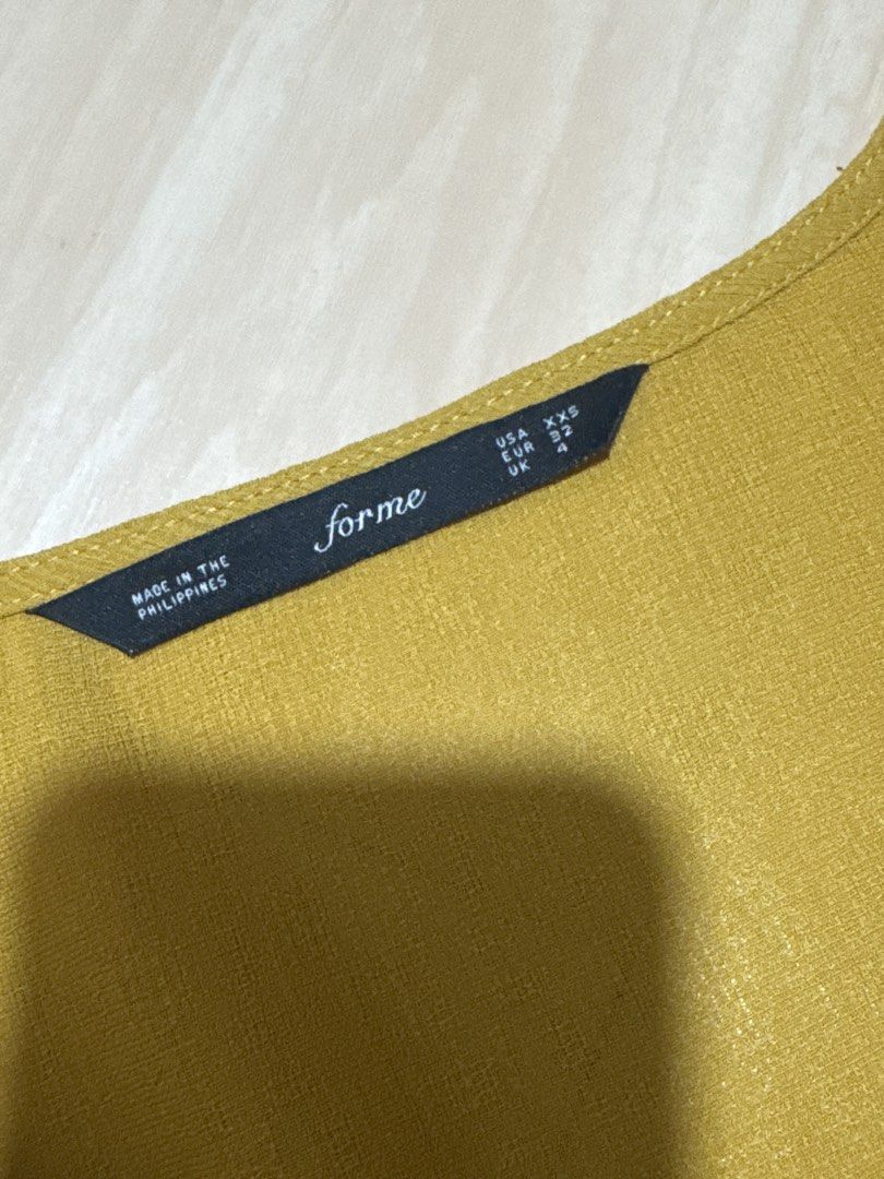 Forme Mustard Yellow V-Neck Top with Button Detail (Category: Blouses) located in Manila. Submitted by sumisloveditems (Listing ID 1456772563, Image 3). Description: Mustard yellow V-neck top size: XXS can fit upto S P300 Mode of payment: Gcash Gotyme Mode of delivery: J&T SDD.