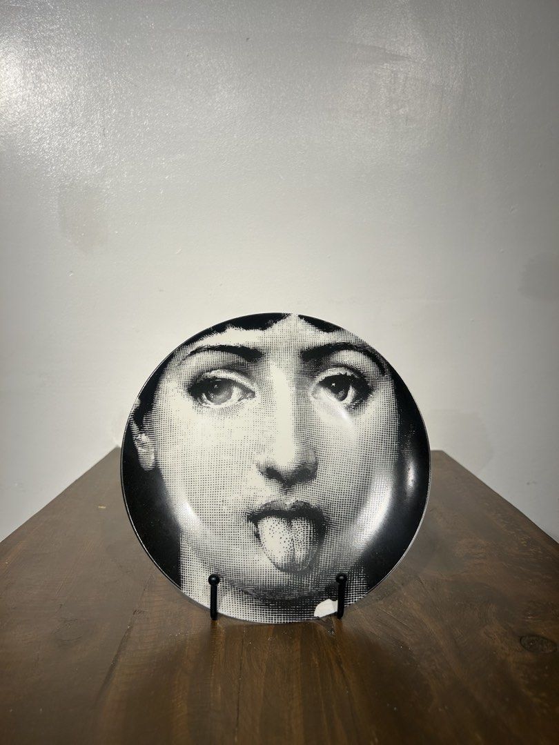 Fornasetti Inspired 10” plates with plate stand (Category: Other Home Decor) located in Pasay City. Submitted by kevgoodflower (Listing ID 1456776333, Image 2). Description: Inspired not authentic Sold as set if 2 w/Free plate stands 10” diameter Wink Tongue out (w/chipping).
