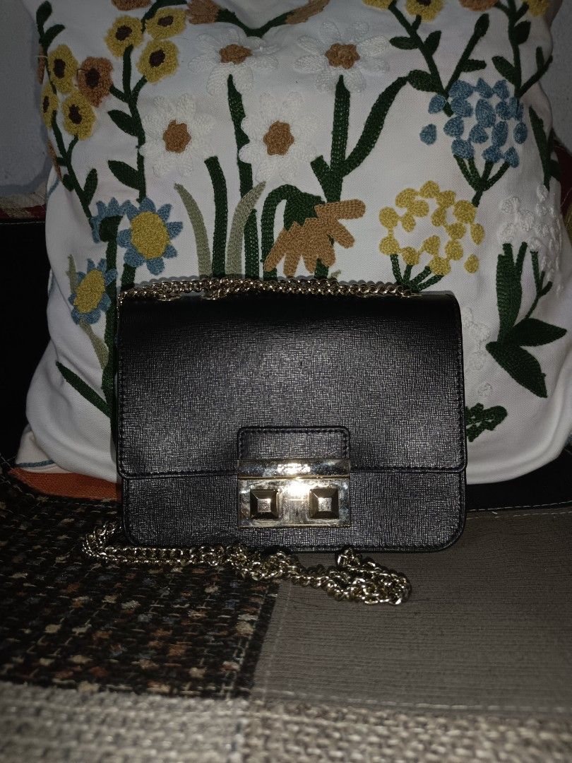 Furla Black Leather Chain Shoulder Bag (Category: Luxury Bags & Wallets) located in Bulacan. Submitted by Ely1112222 (Listing ID 1456656123, Image 1). Description: - Authentic Furla crossbody bag in black - Textured leather exterior for a sophisticated look - Elegant gold hardware with signature Furla logo clasp - Convenient interior card slots - Versatile chain strap - Ideal for both evening events and daily errands.