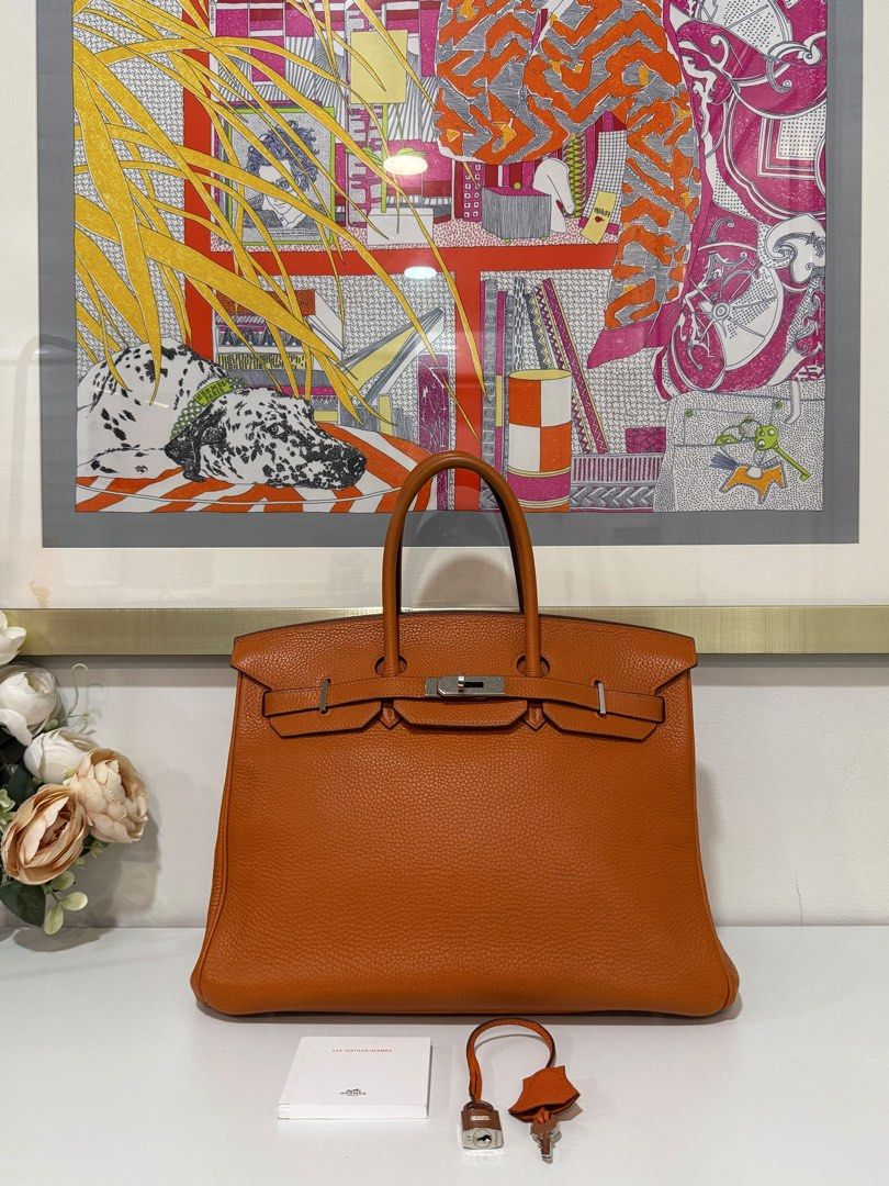 Hermes Birkin 35 (Category: Luxury Bags & Wallets) located in Taguig. Submitted by consumergoodstrading (Listing ID 1456657637, Image 1). Description: Hermès Birkin 35 Orange | Togo Leather | PHW Stamp L — Square A timeless Hermès classic in a vibrant Orange shade — elegant, iconic, and effortlessly luxurious. A beautiful piece for collectors and Hermès enthusiasts alike. Complete Set Includes: • Dust bag • Lock & Keys • Care Card • Box For More 