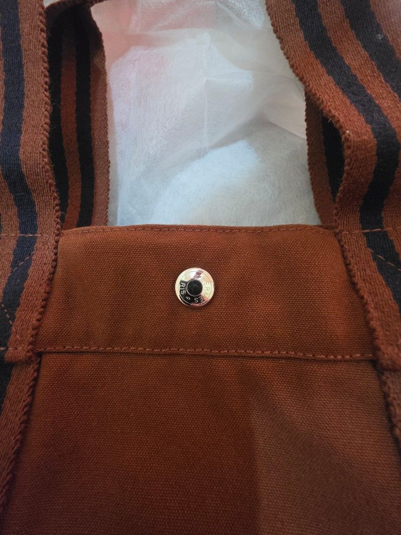 Hermes Fourre-Tout Brown Canvas GM Tote (Category: Luxury Bags & Wallets) located in Cavite. Submitted by kazi_preloved (Listing ID 1456779968, Image 2). Description: - 100% Authentic Hermes Tote bag - Brown canvas tote bag - Secure snap button closure at the top - Spacious main compartment for all your essentials - Interior zippered pocket for added organization - Elegant leather zipper pull with Hermes branding - Ideal for everyday use.