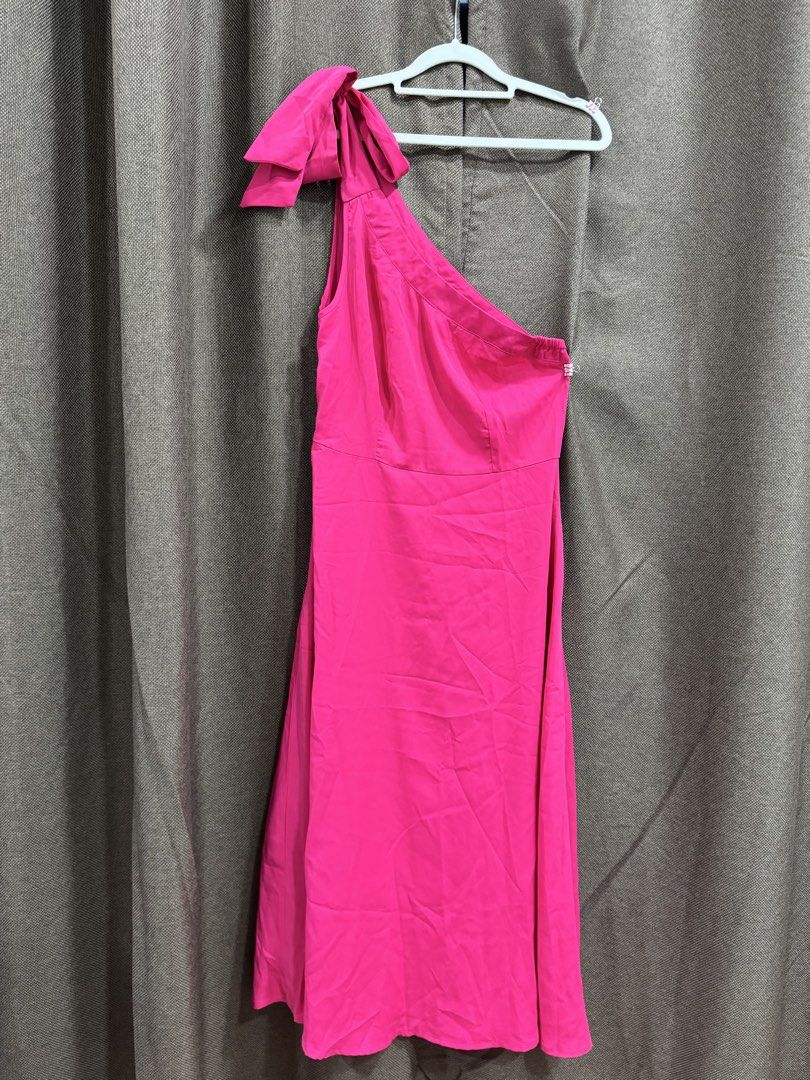Hot Pink One Shoulder Bow Dress (Category: Dresses) located in Guiguinto. Submitted by thehiddenwardrobe (Listing ID 1456736311, Image 1). Description: - Vibrant hot pink color - Flirty one-shoulder design - Adorable bow detail on the strap - Chic midi length - Convenient side zipper closure Makapal po ang tela.
