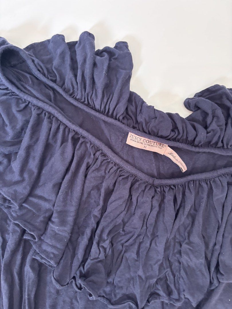 Juicy Couture Navy Blue Ruffle Off-Shoulder Top (Category: Blouses) located in Binan City. Submitted by byhiraeth (Listing ID 1456764034, Image 3). Description: - Juicy Couture navy blue off-shoulder top - Size: Medium (M) - Features cute ruffle details on neckline and sleeves - Made from soft and flowy material - Perfect for dressing up or down.