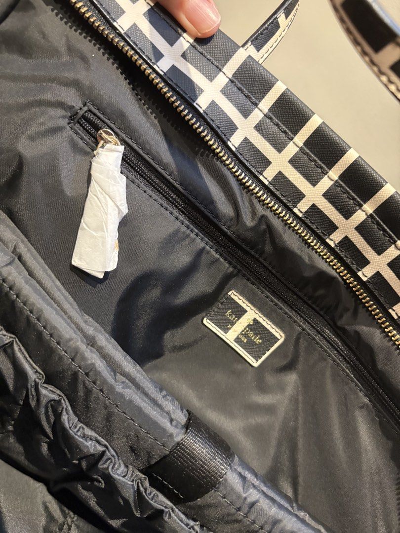 Never Used Kate Spade Diaper Bag with Changing Pad (Category: Diaper Bags & Wetbags) located in Makati City. Submitted by ng2026 (Listing ID 1456621617, Image 2). Description: Very Chic Kate Spade diaper bag - brand new with card and wrapped zipper - ample storage with numerous interior and exterior pockets - includes a convenient changing pad - elegant gold hardware details - ide for parents needing a functional and fashionable bag on the go.