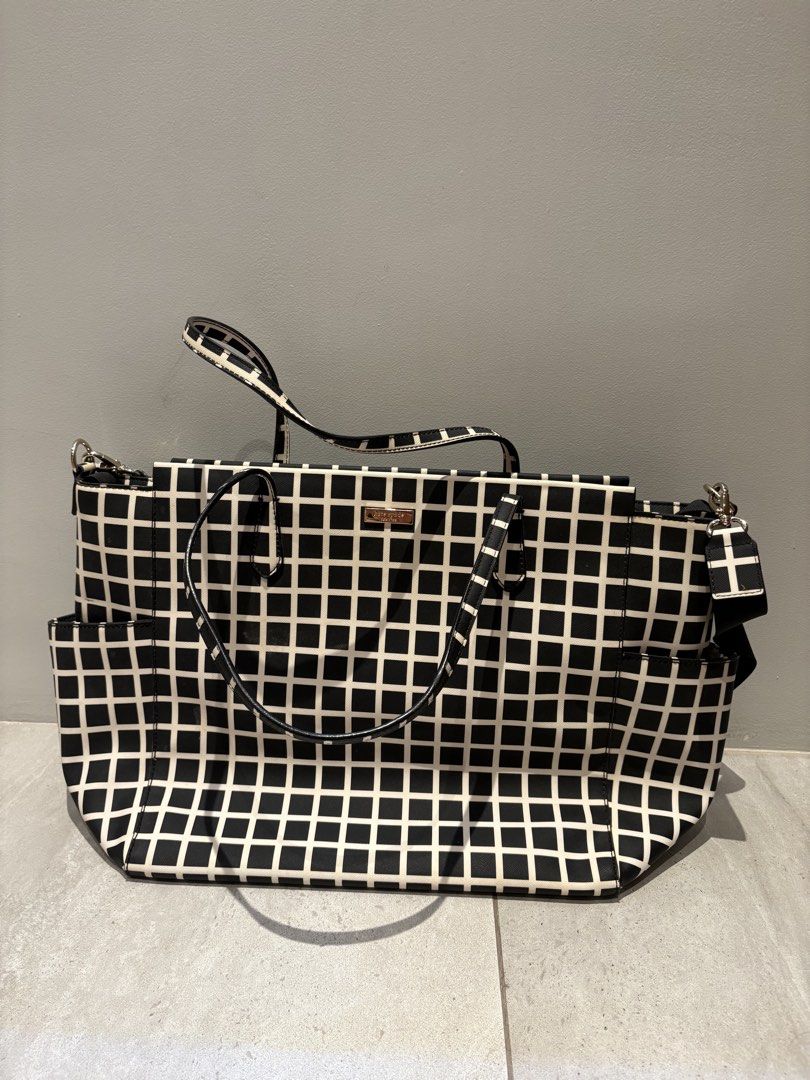 Never Used Kate Spade Diaper Bag with Changing Pad (Category: Diaper Bags & Wetbags) located in Makati City. Submitted by ng2026 (Listing ID 1456621617, Image 1). Description: Very Chic Kate Spade diaper bag - brand new with card and wrapped zipper - ample storage with numerous interior and exterior pockets - includes a convenient changing pad - elegant gold hardware details - ide for parents needing a functional and fashionable bag on the go.