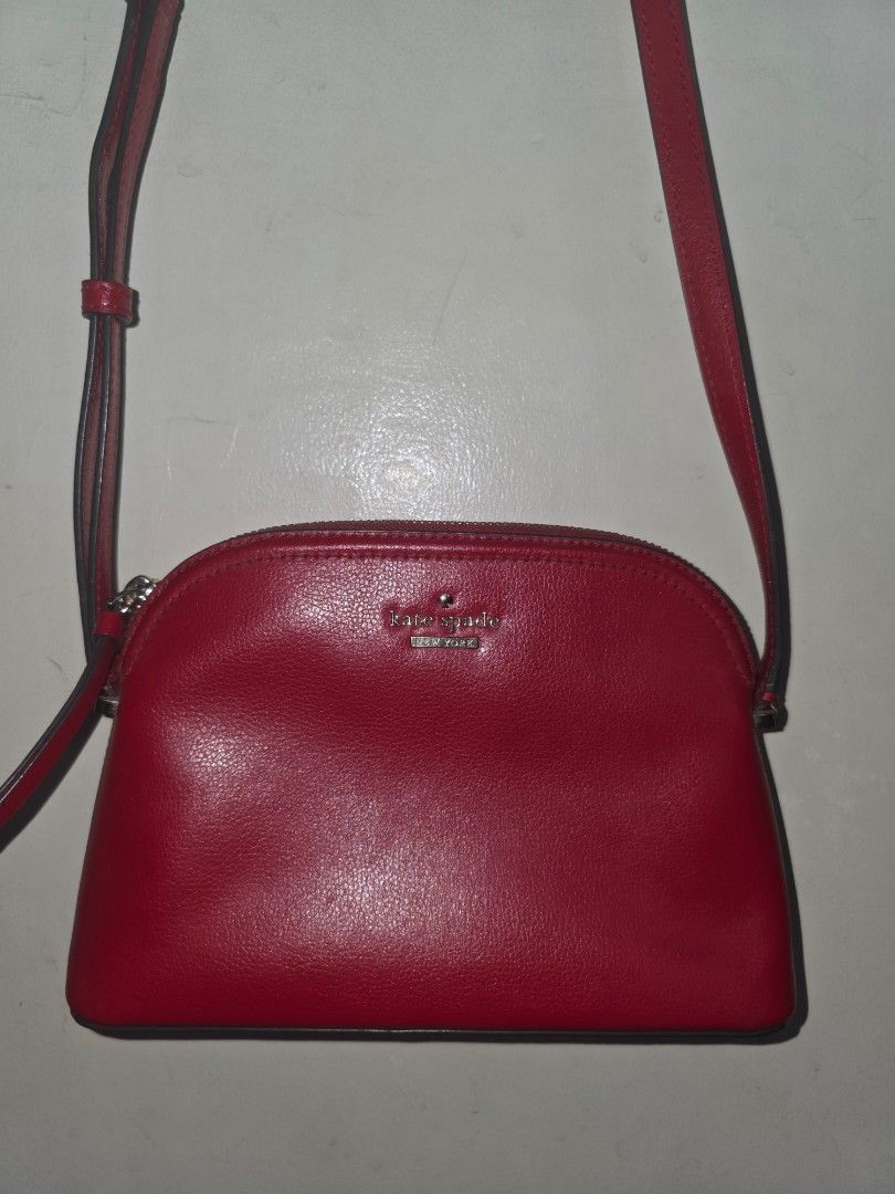 KATE SPADE Red Saffiano Leather Sling Bag (Authentic) (Category: Luxury Bags & Wallets) located in Manila. Submitted by dcory (Listing ID 1456706754, Image 2). Description: Brand: Kate Spade Material: Saffiano Leather Color: Red Width: 9 inches Height: 6 inches Exterior Pockets: One flat pocket Interior Pockets: One flat pocket - Please expect signs of wear and a few scratches since this is a preloved item.