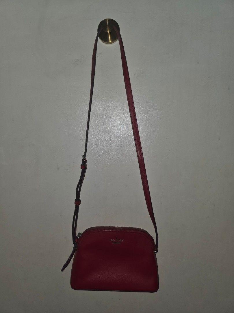KATE SPADE Red Saffiano Leather Sling Bag (Authentic) (Category: Luxury Bags & Wallets) located in Manila. Submitted by dcory (Listing ID 1456706754, Image 3). Description: Brand: Kate Spade Material: Saffiano Leather Color: Red Width: 9 inches Height: 6 inches Exterior Pockets: One flat pocket Interior Pockets: One flat pocket - Please expect signs of wear and a few scratches since this is a preloved item.