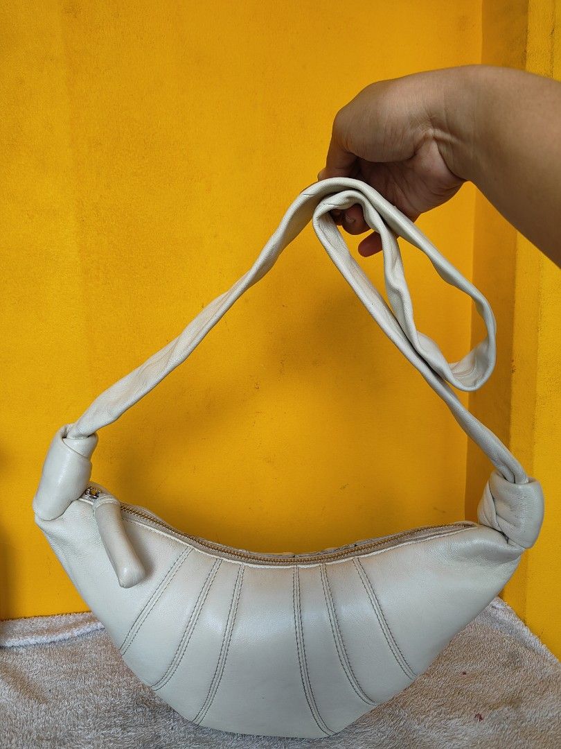 Lemaire White Croissant Shoulder Bag (Category: Luxury Bags & Wallets) located in Cebu City. Submitted by cherreymie70208 (Listing ID 1456723807, Image 1). Description: -Authentic Lemaire Croissant bag - Unique white leather shoulder bag - Trendy croissant shape with elegant pleats - Stylish knotted strap detail - Secure zipper closure - Ideal for everyday wear and carrying your essentials.