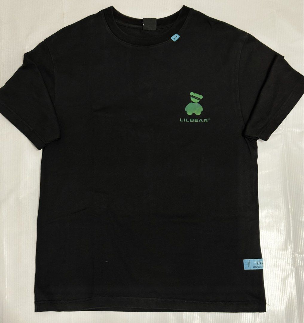 LILBEAR Black T-Shirt with Bear Graphic (Category: Tshirts & Polo Shirts ) located in Quezon City. Submitted by domsselections2 (Listing ID 1456768692, Image 1). Description: - LILBEAR t-shirt - Size: S - Small green bear graphic on the front - Large iridescent bear graphic on the back - Back also features "Since 2020" and "Clothes & Accessories" text - "BRAND NEW MANUFACTURE" tag detail Dimes: 19x26” Black na black 🙌🏻.