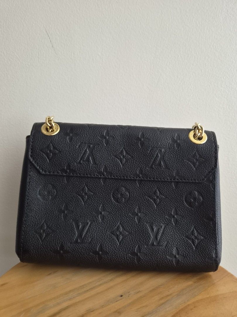 Louis Vuitton Black Monogram Empreinte Vavin BB Shoulder Bag (Category: Luxury Bags & Wallets) located in Mandaluyong City. Submitted by mny_declutters (Listing ID 1456674230, Image 2). Description: - Authentic Louis Vuitton Vavin BB - Color: Black - Material: Monogram Empreinte leather - Hardware: Gold - Strap: Chain strap (Sliding, NOT Removable) - Includes: Dust bag, Original Box and Paper Bag (not in photo, can be requested) - Versatile: Idea