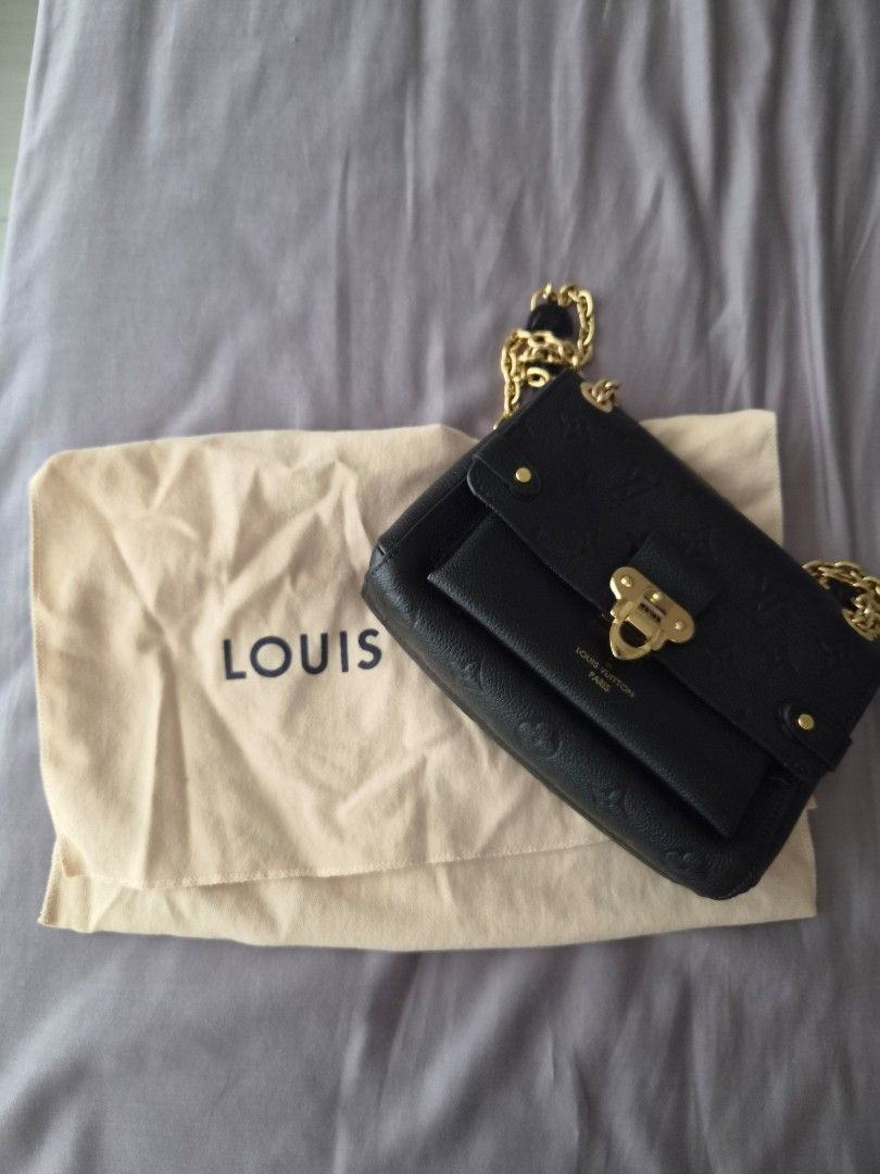 Louis Vuitton Black Monogram Empreinte Vavin BB Shoulder Bag (Category: Luxury Bags & Wallets) located in Mandaluyong City. Submitted by mny_declutters (Listing ID 1456674230, Image 3). Description: - Authentic Louis Vuitton Vavin BB - Color: Black - Material: Monogram Empreinte leather - Hardware: Gold - Strap: Chain strap (Sliding, NOT Removable) - Includes: Dust bag, Original Box and Paper Bag (not in photo, can be requested) - Versatile: Idea