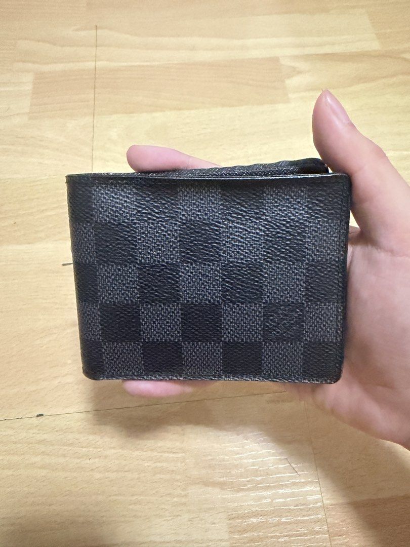 Louis Vuitton Damier Graphite Bifold Wallet (Category: Luxury Bags & Wallets) located in Manila. Submitted by coolfish_47135c (Listing ID 1456730159, Image 1). Description: - Authentic Louis Vuitton Wallet - Damier Graphite Canvas - Bifold Style - Multiple Card Slots - Bought in France - Shows some signs of use, still in good shape.