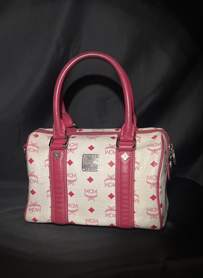 MCM Monogram Boston Bag with Pink Leather Trim (Category: Luxury Bags & Wallets) located in Las Pinas. Submitted by lyrehs1981 (Listing ID 1456658123, Image 2). Description: - Classic MCM Boston bag - Color: White with pink MCM monogram print - Trim and handles: Pink leather - Hardware: Silver-tone - Closure: Zipper - Ideal for everyday use or travel Minimal sign of usage.