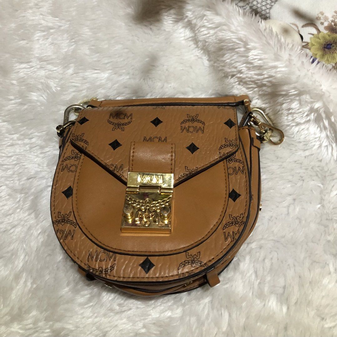 MCM Visetos Mini Backpack Cognac Gold Hardware (Category: Luxury Bags & Wallets) located in Meycauayan. Submitted by miletteaqu82717 (Listing ID 1456663622, Image 1). Description: - MCM Mini Bag - Classic cognac color with iconic Visetos print - Gold hardware details - Interior features card slots and a main compartment - Adjustable straps - Ideal for everyday use - signs of wear.