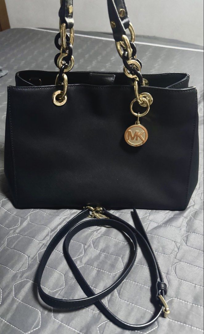 Michael Kors Black Leather Bag with Gold Hardware (Category: Luxury Bags & Wallets) located in Manila. Submitted by jonn1 (Listing ID 1456644681, Image 1). Description: - Genuine black leather Michael Kors tote bag - Elegant gold chain detail on handles - Comes with a detachable shoulder strap for versatility - Features multiple interior compartments and a secure zip pocket - Adorned with a signature MK logo charm - Ideal for everyday style and f