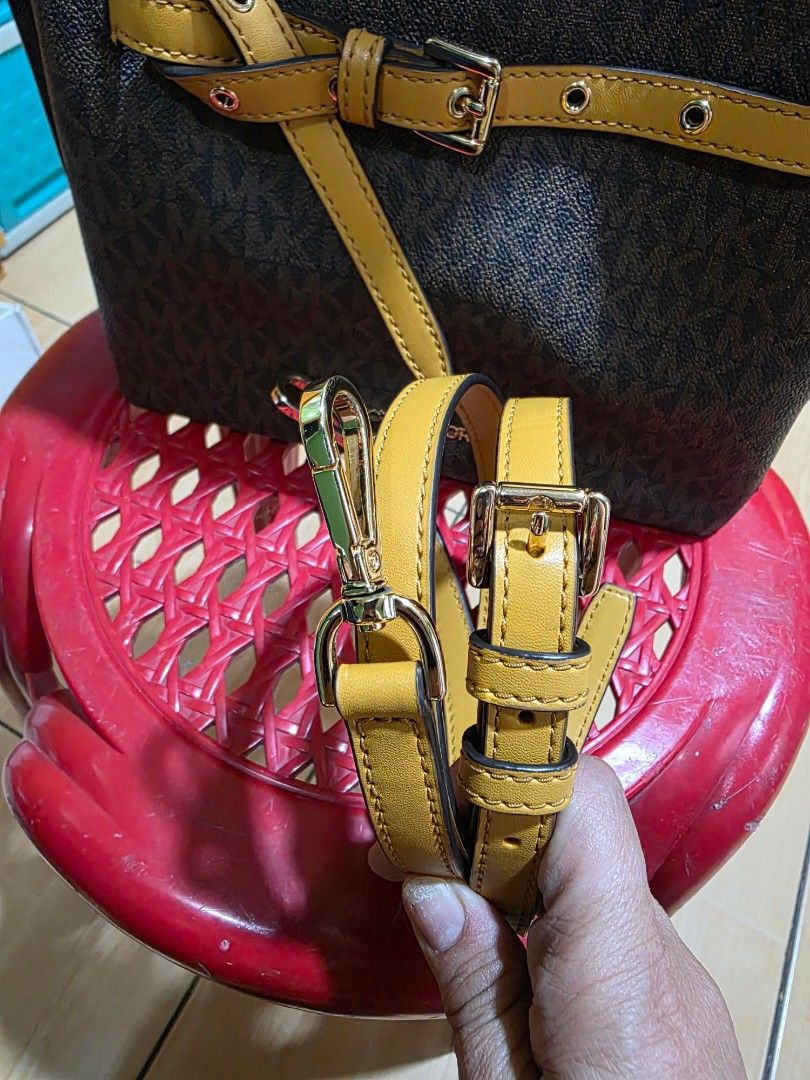Michael Kors Monogram bag with Yellow Leather Accents (Category: Backpacks) located in Manila. Submitted by dhabbie2 (Listing ID 1456741674, Image 2). Description: - Michael Kors signature monogram print backpack small emilia - Yellow leather trim and straps - Gold hardware details - Secure zipper closure - Adjustable shoulder straps - Includes a detachable crossbody strap - Ideal for everyday use or travel.
