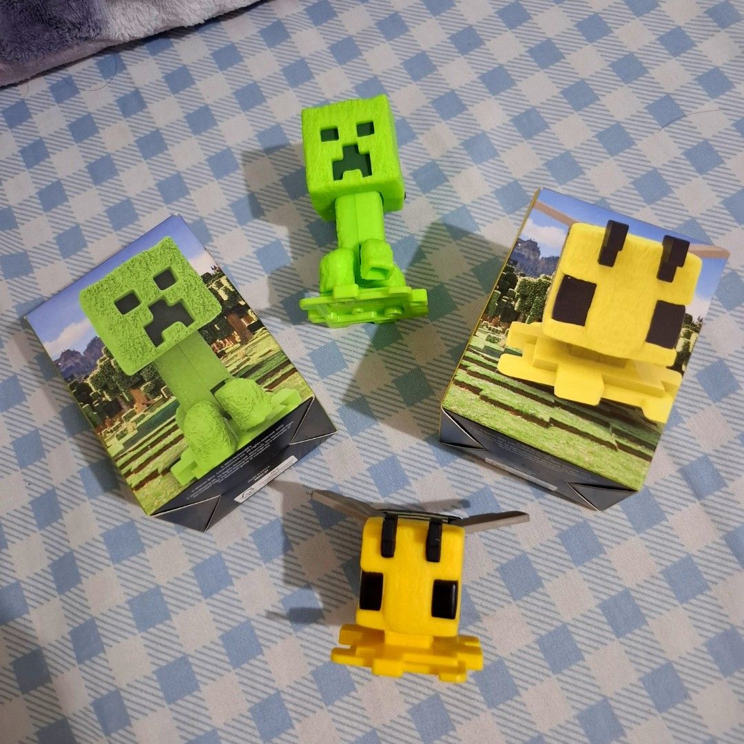 Mcdo x Minecraft Happy Meal - Creepe and Bee (Category: Designer & Blind Box Toys) located in Antipolo. Submitted by biapreloves (Listing ID 1456703984, Image 1). Description: MCDONALDS X MINECRAFT (A MINECRAFT MOVIE) HAPPY MEAL - Selling as set only (creeper and bee) - 150.00 for set - not displayed, kept in box only (took out to take a photo) - no visible damages/scratches/chip offs on the figure Loc: Lower Antipolo MOP: gcash / ub MOD: direct 