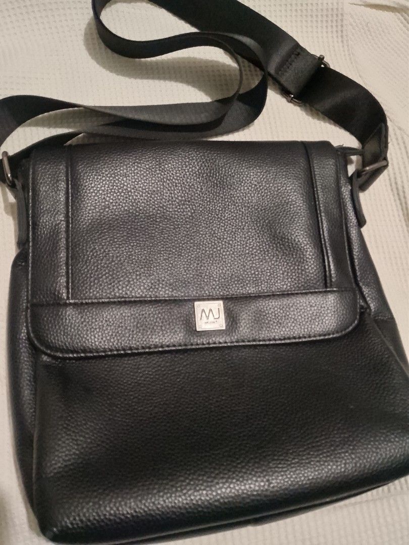 MJ Black Leather Messenger Bag (Category: Luxury Bags & Wallets) located in Manila. Submitted by freewolf.d719f8 (Listing ID 1456718962, Image 1). Description: - MJ Sport black leather messenger bag - Main compartment with internal zip pockets - Additional zip pocket on the back - Adjustable strap for comfort - Plenty of space, ideal for daily use or travel.