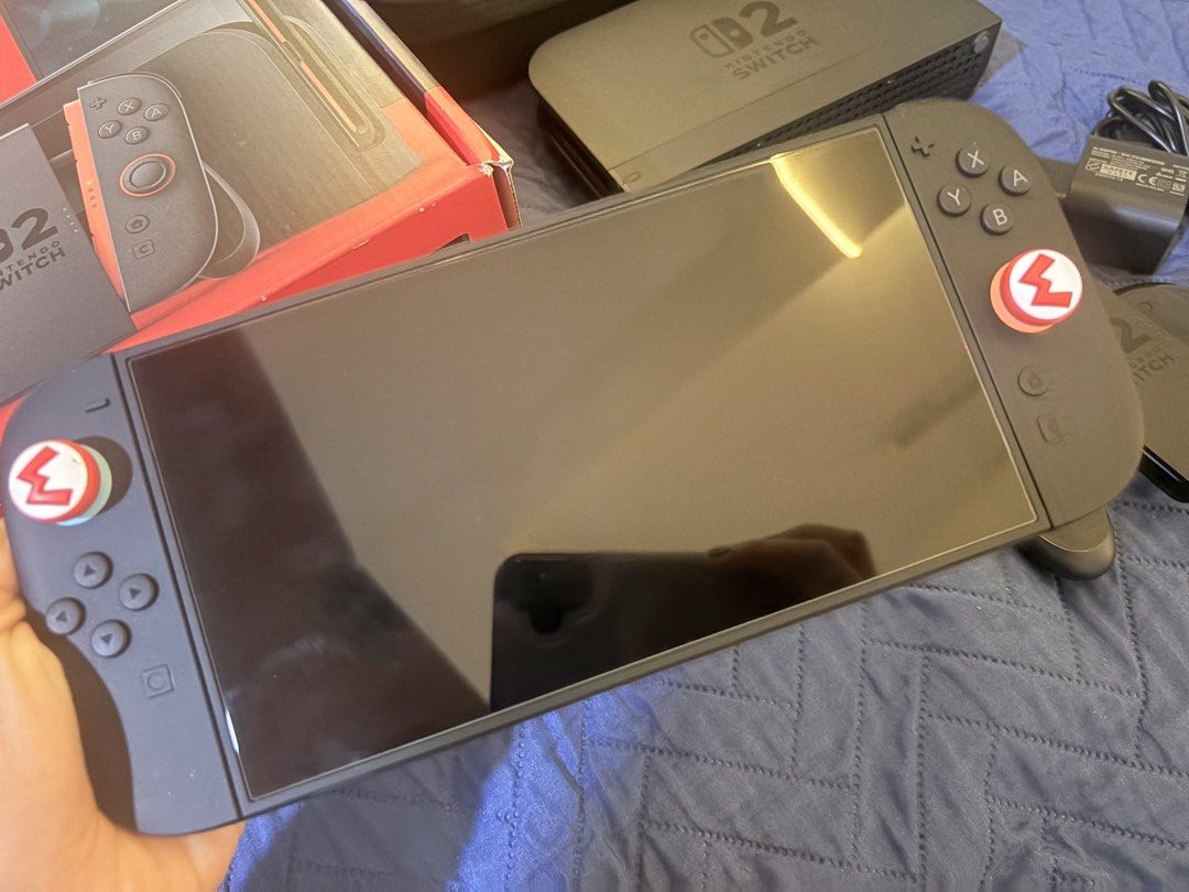 Nintendo Switch 2 (Category: Nintendo) located in Bacoor. Submitted by jqt1996 (Listing ID 1456724189, Image 2). Description: - no dents - no issue - w case - complete w box - ac adapter - charging cable - dock - joycon 2 grip - joycon straps - hdmi - w screen protector - only 1 month old - bought for 31k - rfs: may nag-regalo ng panibago so need to sell.