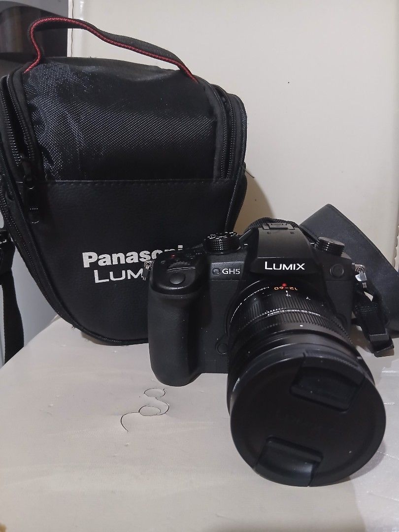 Panasonic Lumix G GH5L Digital Camera Lens Kit (Category: Cameras) located in Quezon City. Submitted by puchi.cat (Listing ID 1456683943, Image 1). Description: - Panasonic Lumix GH5L digital camera body - Leica DG Vario-Elmarit 12-60mm lens - Panasonic Lumix G camera bag - Original box and packaging included - Ideal for high-quality 4K video and photography original price is 122k, selling it for 99k (negotiable). Only used a couple of times. .