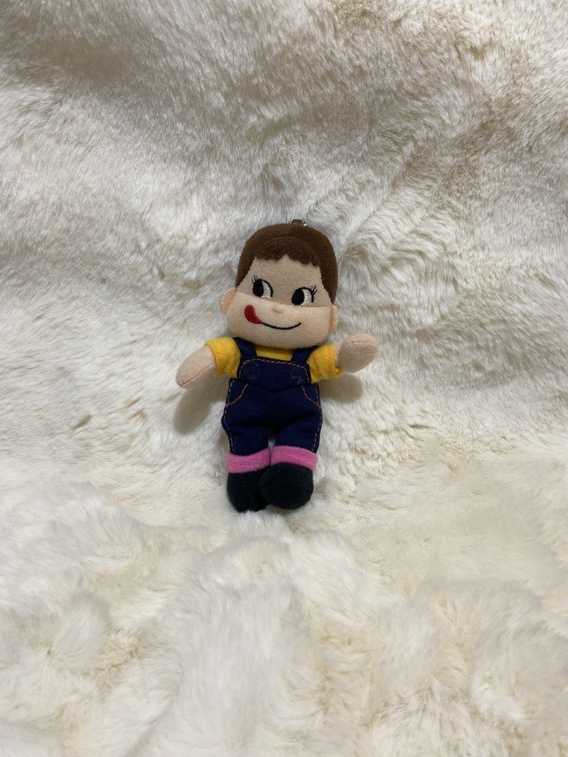 Peko-Chan Plush Charm Keychain (Category: Plushies & Soft Toys) located in Kalibo. Submitted by ollie_stuffshop (Listing ID 1456683293, Image 1). Description: Before you send your inquiries: ❗️Last Price is already posted ❗️Manage your expectations, WYSIWYG ❗️May need washing ❗️Shipping day is every Sunday - Adorable plush toy - Brown hair and yellow shirt - Blue overalls with pink accents - Cute tongue-out expression - Includes metal keychain lo