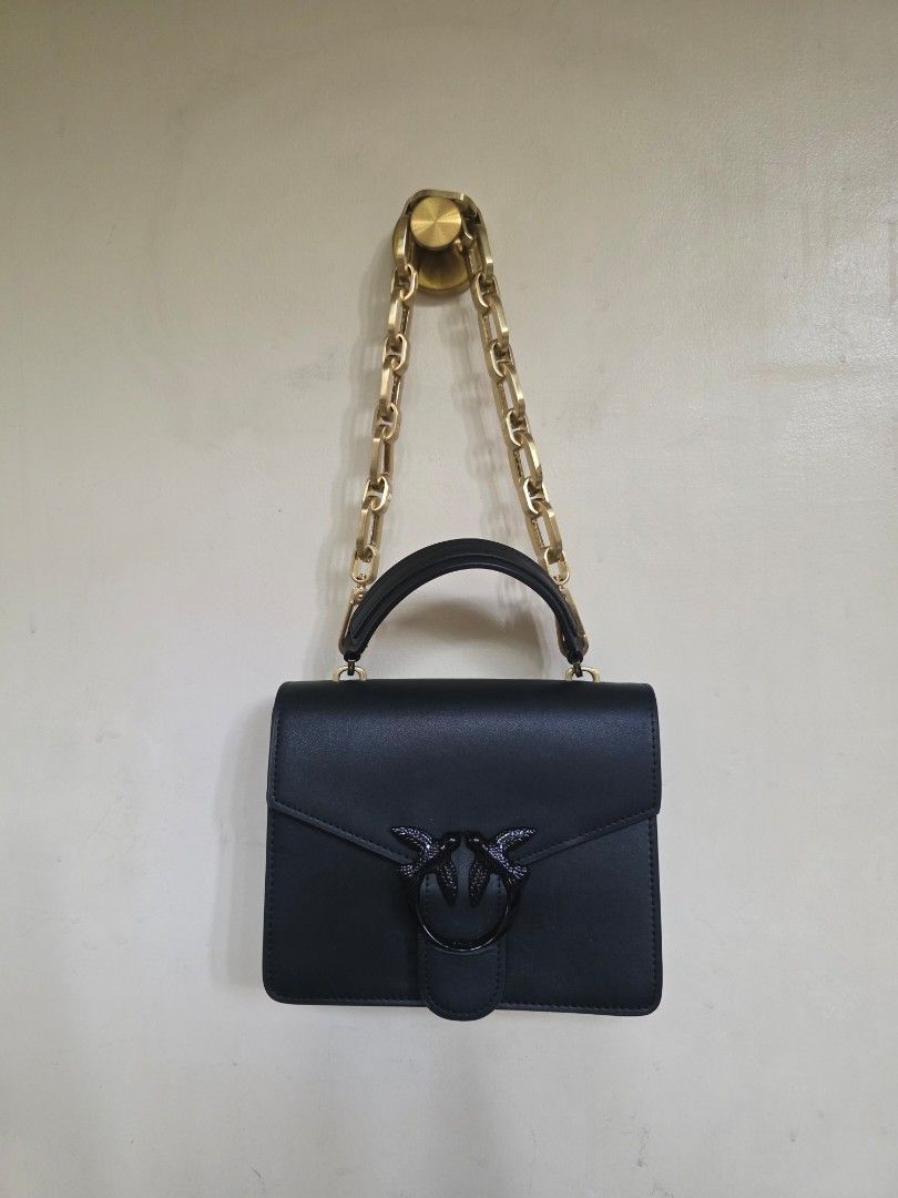 PINKO Black Leather Shoulder/Top Handle Structured Bag (Category: Luxury Bags & Wallets) located in Manila. Submitted by dcory (Listing ID 1456681366, Image 2). Description: Brand: Pinko Material: Leather Color: Black Width: 9 inches Height: 7.5 inches Interior Pockets: One flat pocket - Please expect signs of wear and a few scratches since this is a preloved item.
